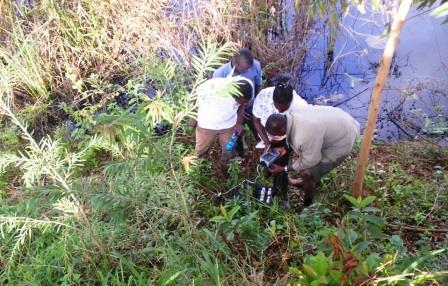 Students recording pH for Theta Dam, in Kiambu County as part of AGE 867: Watershed Evaluation